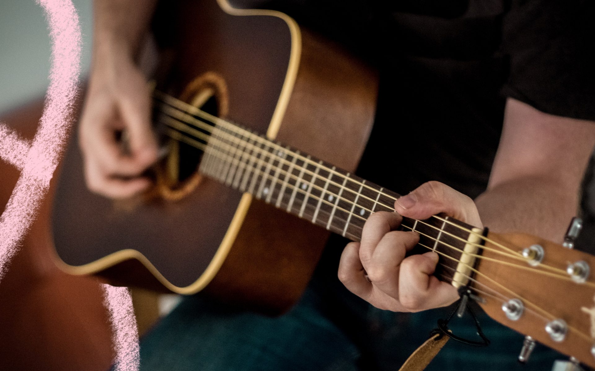 the photo shows a guitar being played