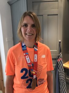 the photo shows our Claire with her London Marathon finishing medal around her neck and smiling straight at the camera