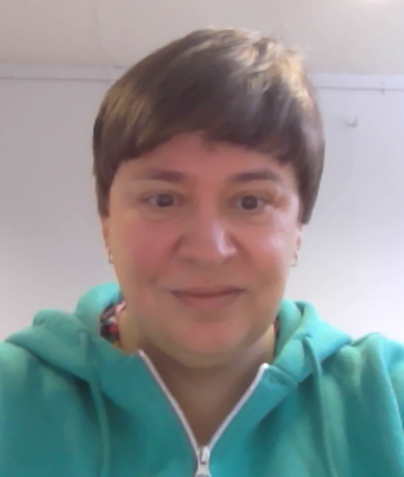 the photo shows our staff member Clare inside and smiling at the camera