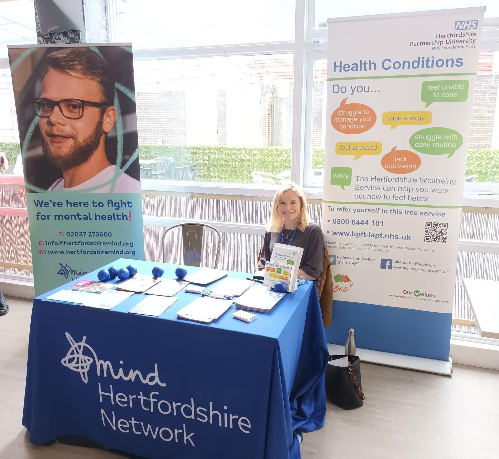 Our Wellbeing Access workers staffing a promotional stall at an event.