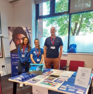 Our Wellbeing Access workers staffing a promotional stall at an event.