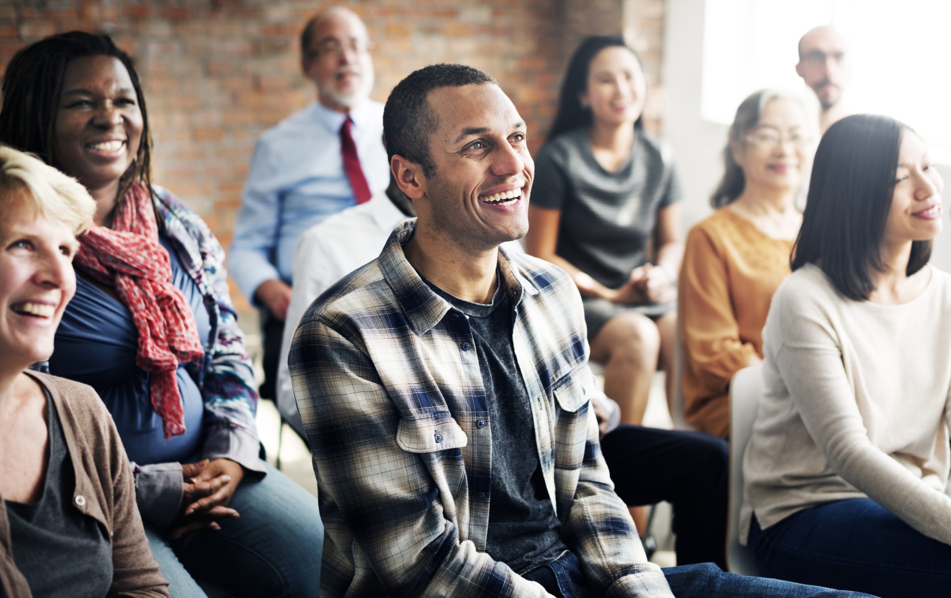 A group of people listening to a speaker.