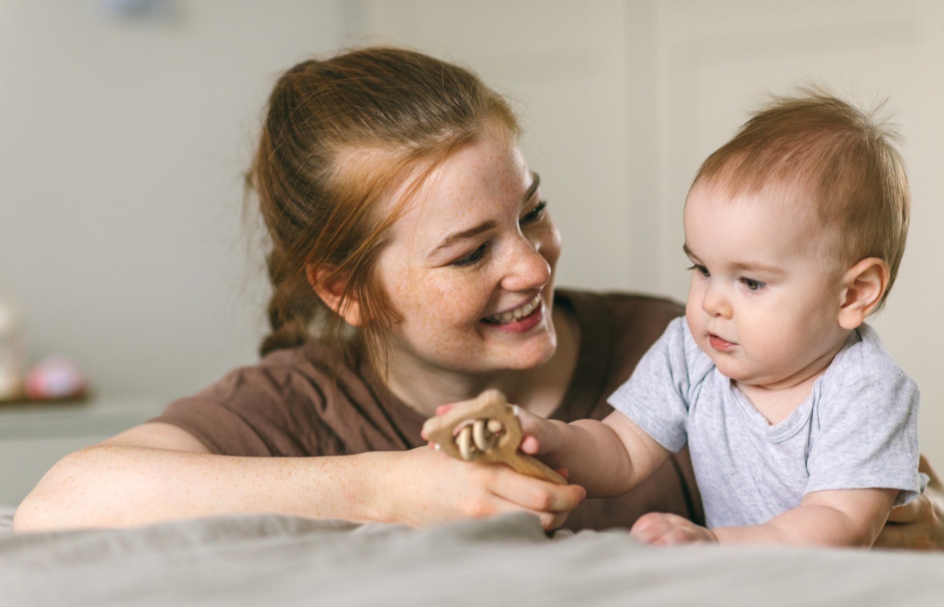 A smiling Mum spending time with her baby
