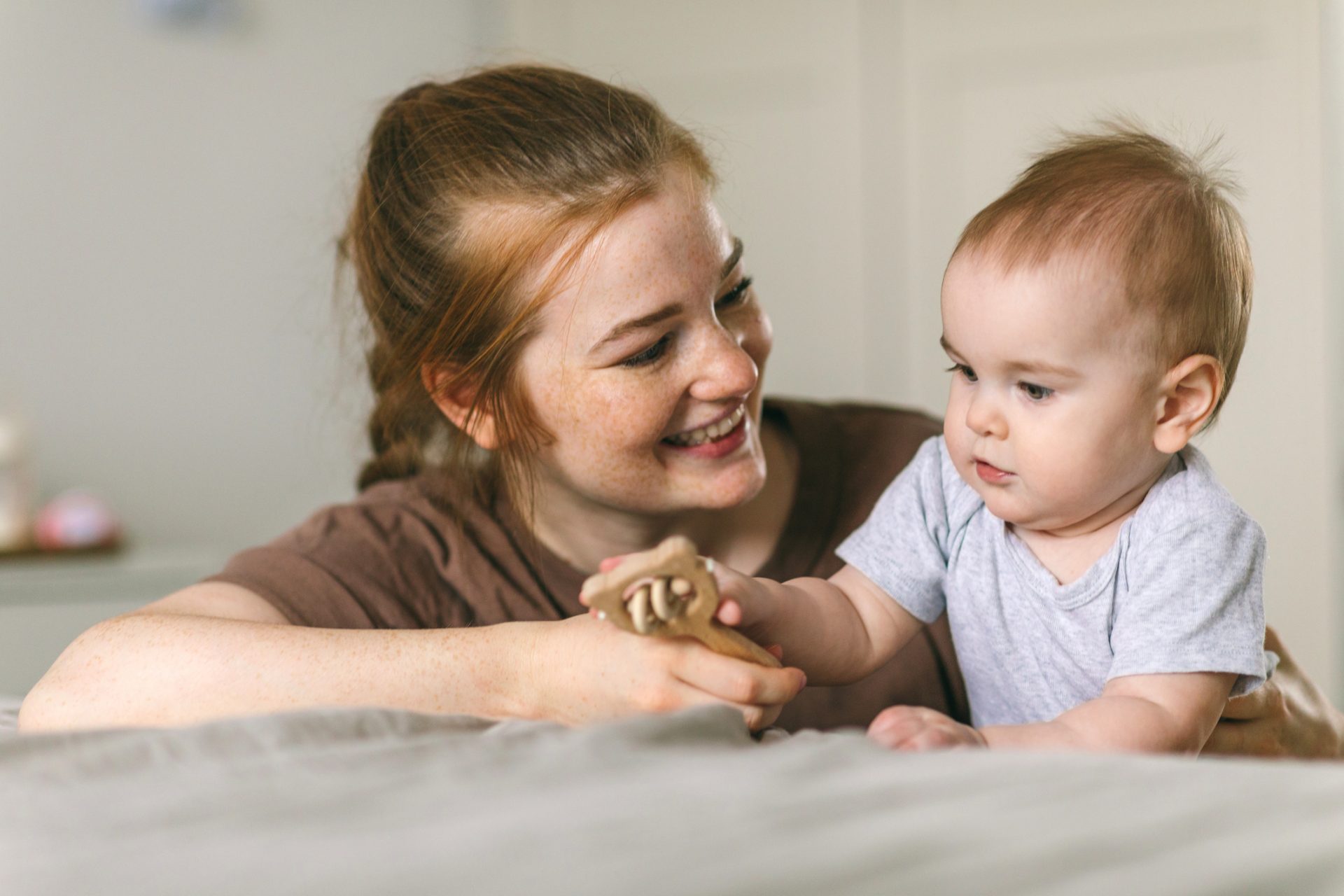 A smiling Mum spending time with her baby